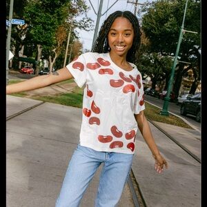 NWT Queen of Sparkles White Red Beans & Rice Tee Small